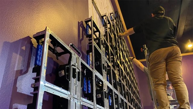 LED display installation in progress with mounting structure and technicians onsite